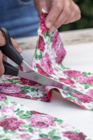 Using scissors to cut out fabric
