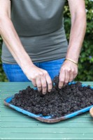 Mixing compost and clay together