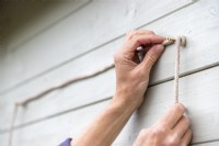 Tying sash cord around screws