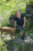 Anita van Zantvoort owner tea garden: 'Under the green heaven' and her dog.