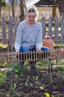 Adding picket fence border edging panel to the vegetable bed.