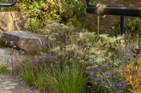 M&G Garden, transforms an urban wasteland, incorporating the old pipes that are softend and surrounded by flowers. Plants include: Anemone hupehensis September Charm', Pennisetum alopecuroides 'Cassian',  Acanthus hungaricus 'White Lipsâ€™ seedheads, Heuchera villosa Autumn Bride and Patrinia punctiflora. 