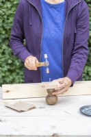 Attatching the wooden square to the end piece with a nail