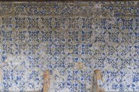 Wall of glazed blue tiles known as Azulejos in poor condition. Seixal, near Setubal, Portugal. September