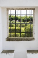 View through window in wall of the Box Parterre. - Jardim de Buxo. Seixal, near Setubal, Portugal. September