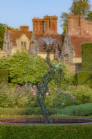 View of a modern figurative fountain in a country garden in autumn - September