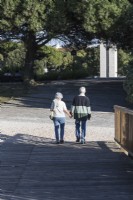 Senior couple holding hands and walking in the park. Lisbon, Portugal. September. 