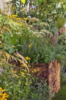 Large container planted with perennials and grasses. The Parsley Box Garden at Chelsea Flower Show 2021