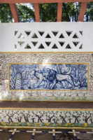 Pergola with back wall of decorative glazed tiles known as Azulejos and containing a bench also tiled. Belem district, Lisbon, Portugal, September. 