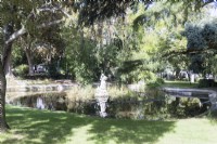 Sculpture of woman in the middle of the pond. Estrela district, Lisbon, Portugal, September. 