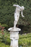 Lead sculpture on man on plinth on the Formal Garden. Lisbon, Portugal, September.