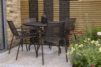 Table and chairs on patio in small suburban garden