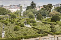 View over the formal Box parterre with view outside the garden to the city. Lisbon, Portugal, September.