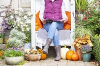 Woman sitting outside in Autumnal setting reading magazine