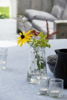 Vase of garden flowers on table.