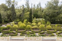View over the Old Labyrinth Garden. Low hedges of clipped Box with planting of mostly pomegranate tees in beds within hedges. Queluz, Lisbon, Portugal, September. 