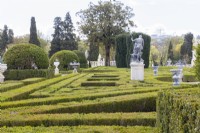 View across tops of Buxus - Box - hedges to topiary and statues. Queluz, Lisbon, Portugal, September. 