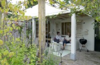 Relaxing in the summer house under the grape pergola.