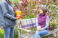 Two women talking in the garden