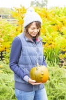 Woman holding a pumpkin