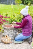 Woman planting bulbs in the pot