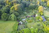 View over whole garden and surrounding properties and woodland; image taken with drone. July. Summer.