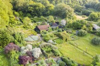 View over whole garden with house in the centre; image taken with drone. July. Summer.