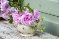 Posy of pink roses displayed in vintage china teapot