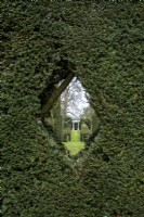 Formal gardens with Yew hedging and small 'peephole' for viewing garden beyond