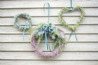 Scented wreaths hanging on a wooden wall