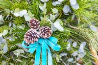 Pine cones and blue ribbon bow on decorative star