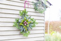 Evergreen star hanging on a pale green wooden wall