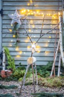 Large birch reindeer with fairy lights on its antlers
