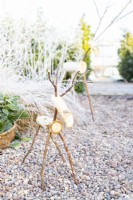 Wooden reindeer in a gravel garden