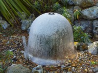Winter protection. Agave plant protected with rockery bell cloche for insulation and protection from frost.