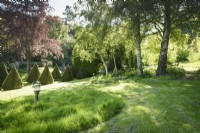 Sundial on a sloping lawn at the Old Rectory, Netherbury, Dorset in May