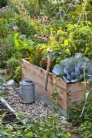 Organic kitchen garden with raised beds and garden tools.