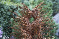 Rusty sculpture of male and female by Penny Hardy. Chelsea Flower Show 2021.
