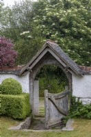 Beautiful entrance gate with porch in old cottage garden in Cornwall