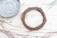 Birch wreath laid out on wooden surface