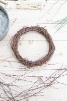 Home made birch wreath lying on wooden surface