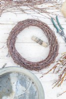 Homemade birch wreath lying on a wooden surface