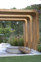 Finding Our Way: An NHS Tribute Garden. Designer: Seating area with modern timber canopy. Naomi Ferrett-Cohen. Chelsea Flower Show 2021.