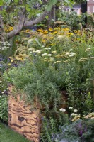 A wooden crate is planted with rosemary, alliums, achillea and catmint.