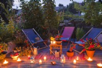 Roof terrace with candles and lantern in the evening.