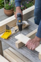 Step-by-Step Making a Potting Bench. Step 2: using a thin drill bit, make guide holes for the screws