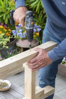 Step-by-Step Making a Potting Bench. Step 5: attach legs to support pieces that hold the bottom shelf in place