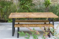 A contemporary, timber picnic table and benches.
