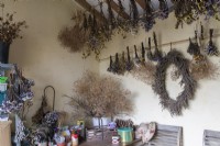 Interior of a garden shed with bunches of dried flowers.