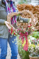 Woman holding heart wreath